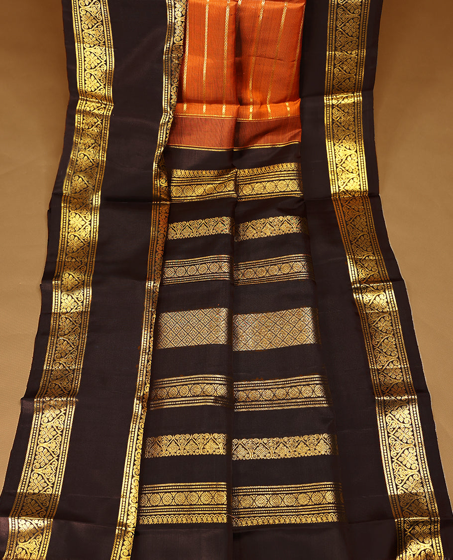 Rust orange Colour pure traditional Kancheepuram silk saree adorned with antique zari horizontal lines on the body, elegantly complemented by a traditional border, and paired with a matching blouse.