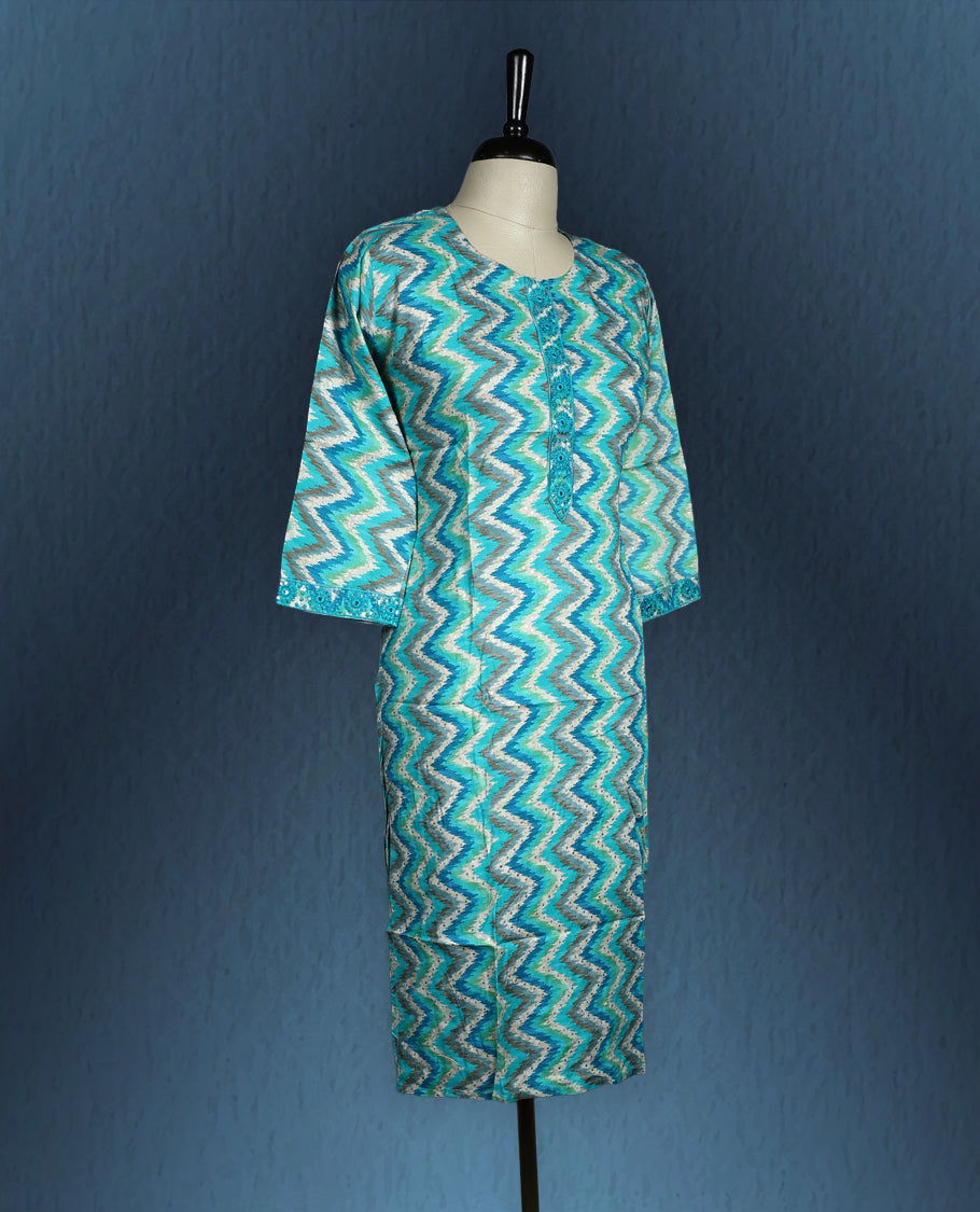 Aqua blue colour kurti with an all over zigzag pattern in shades of white and teal, styled with a round neckline featuring a short button placket, and complemented by three quarter sleeves