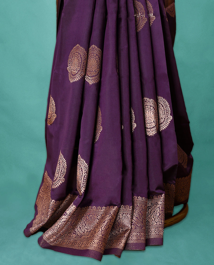 Royal Grape coloured semi silk saree featuring a Golden Zari design on the body, paired with a Self coloured border and matching blouse.