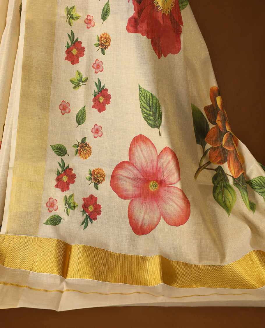 Elegant off white colour tissue Kerala saree with vibrant floral prints and a shimmering golden zari border, Lightweight and graceful, perfect for festive or traditional occasions & Includes matching blouse piece.