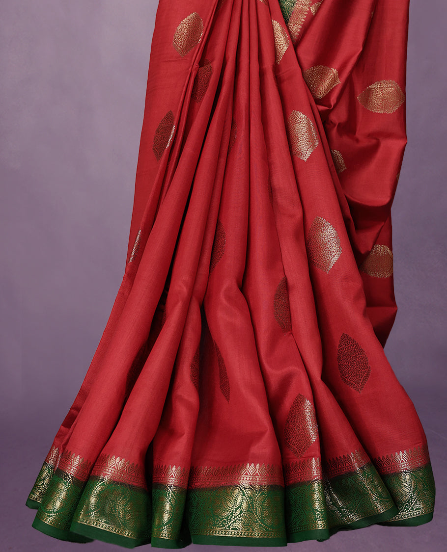 Chilly Red Colour Pure Banaras Soft Silk Saree adorned with traditional antique zari motifs, paired with a hand dyed Dark Green antique style border and a matching blouse.