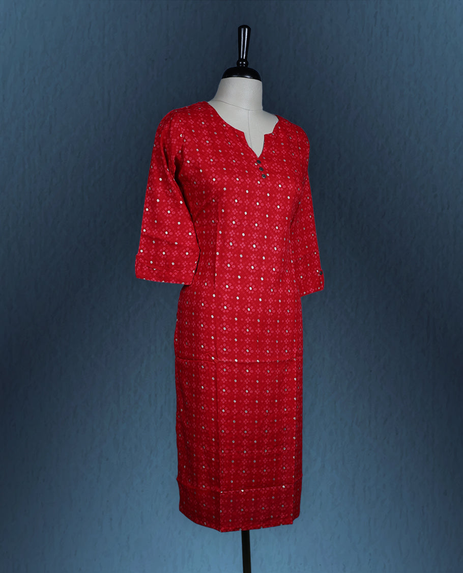 Red colour kurti adorned with an all over small geometric print, styled with a chic notch neckline enhanced by delicate button detailing, and finished with comfortable three quarter sleeves