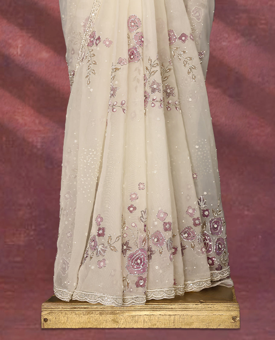 White colour pure organza saree featuring Light Purple floral prints with intricate bead and sequin work across the body, adorned with a matching embellished border, complemented by a worked pallu and paired with a heavily worked matching blouse.