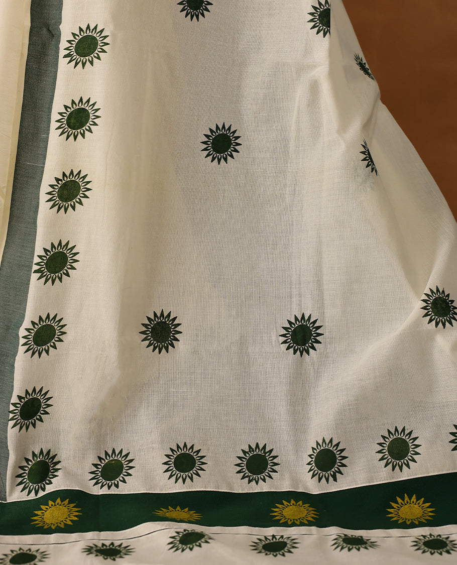 Elegant off white colour cotton Kerala saree featuring Plain body, Green colour border with Flower Block prints, Paired with matching blouse offering a classic and graceful look