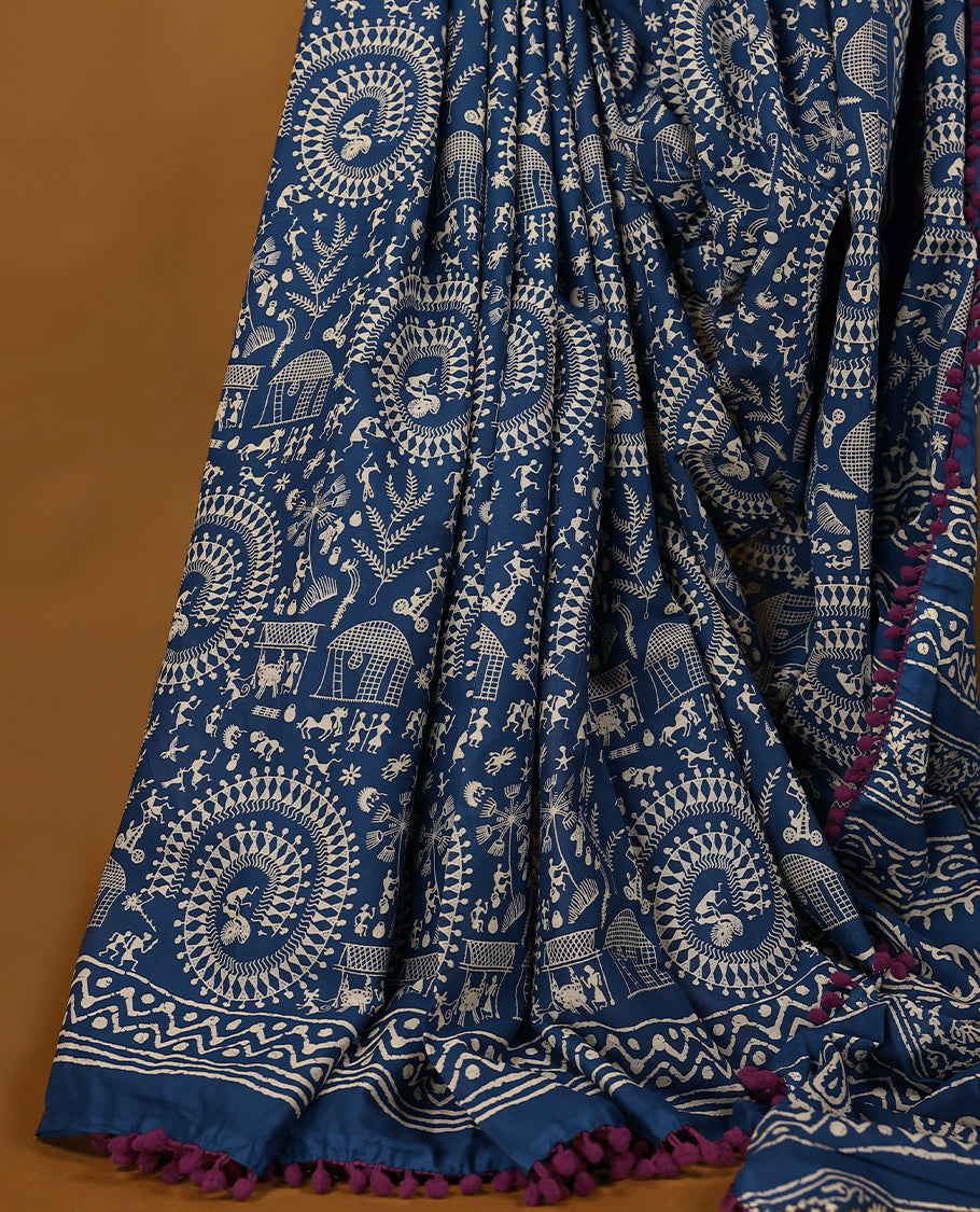 Blue cotton saree features intricate off-white handblock prints, a beautifully detailed border with Grape piping and Self Coloured Blouse