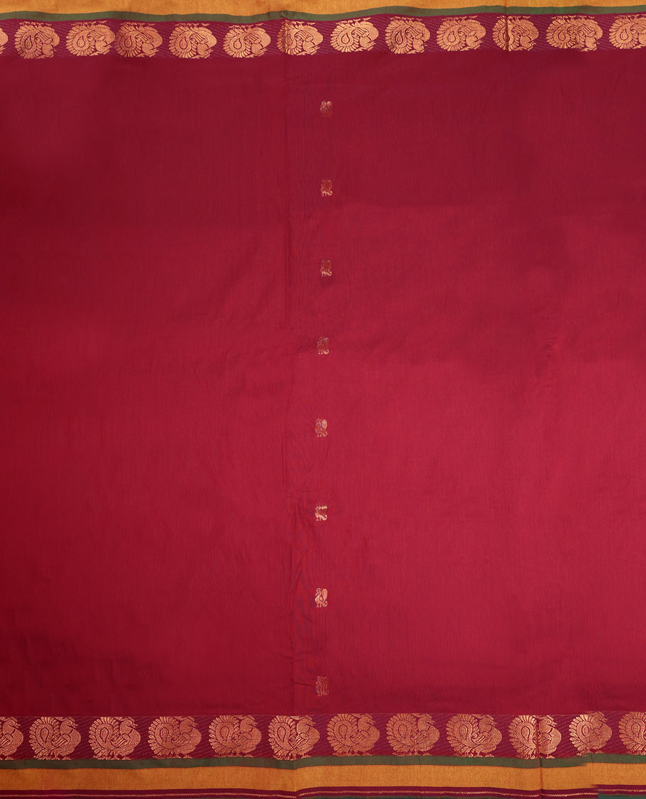 Maroon and Bottle Green Kalyani cotton saree adorned with traditional peacock motifs, enhanced by a rich woven zari border and pallu in green, paired with a matching blouse.