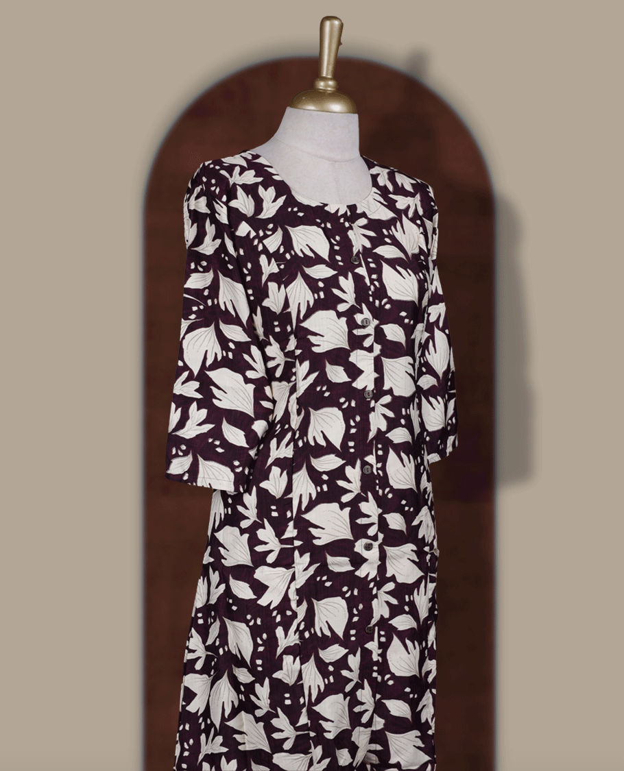 Wine colour kurthi featuring bold off white colour floral prints, a round neckline with front button detailing, and comfortable 3/4th sleeves & Designed in a flattering A line silhouette, perfect for casual outings and everyday elegance.
