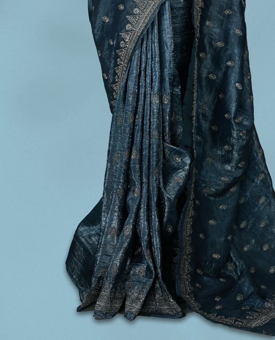 Midnight Blue Colour crush soft silk saree, textured body with a natural crinkled finish, adorned with intricate Silver colored floral Motifs and complemented by a delicate Silver Zari embroidery border, paired with a matching blouse