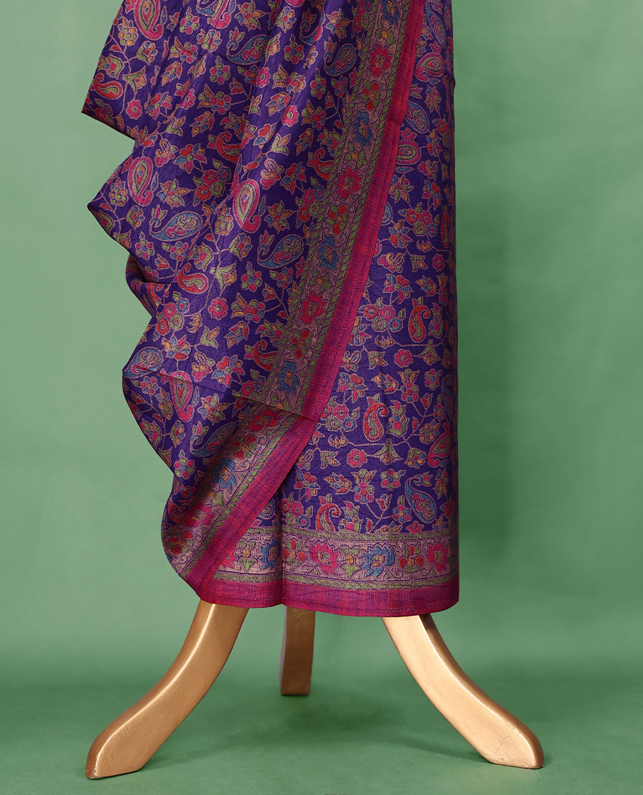 Purple Colour saree with multicolour floral and paisley motifs, detailed Contrast border, and a traditional design that comes with a matching blouse.