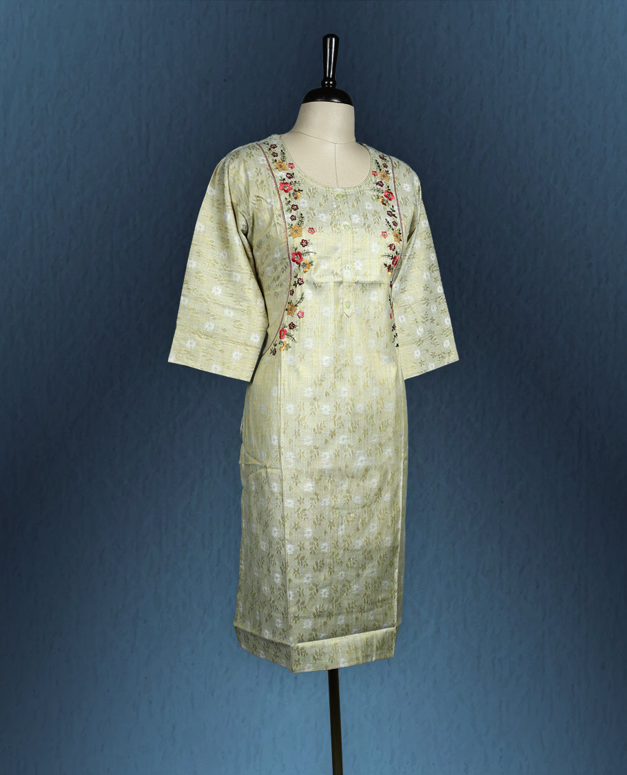 Pistachio green colour kurti with subtle floral self weave, adorned with delicate multicolour floral embroidery along the princess line, featuring a round neckline and stylish three quarter sleeves.