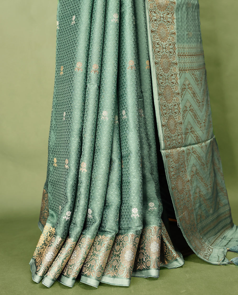 Pastel Green colour pure Banaras crepe saree showcases elegant silver zari Flower Motifs all over the body, a traditional Banarasi gold zari border, a rich intricately woven pallu, and comes with a matching blouse.