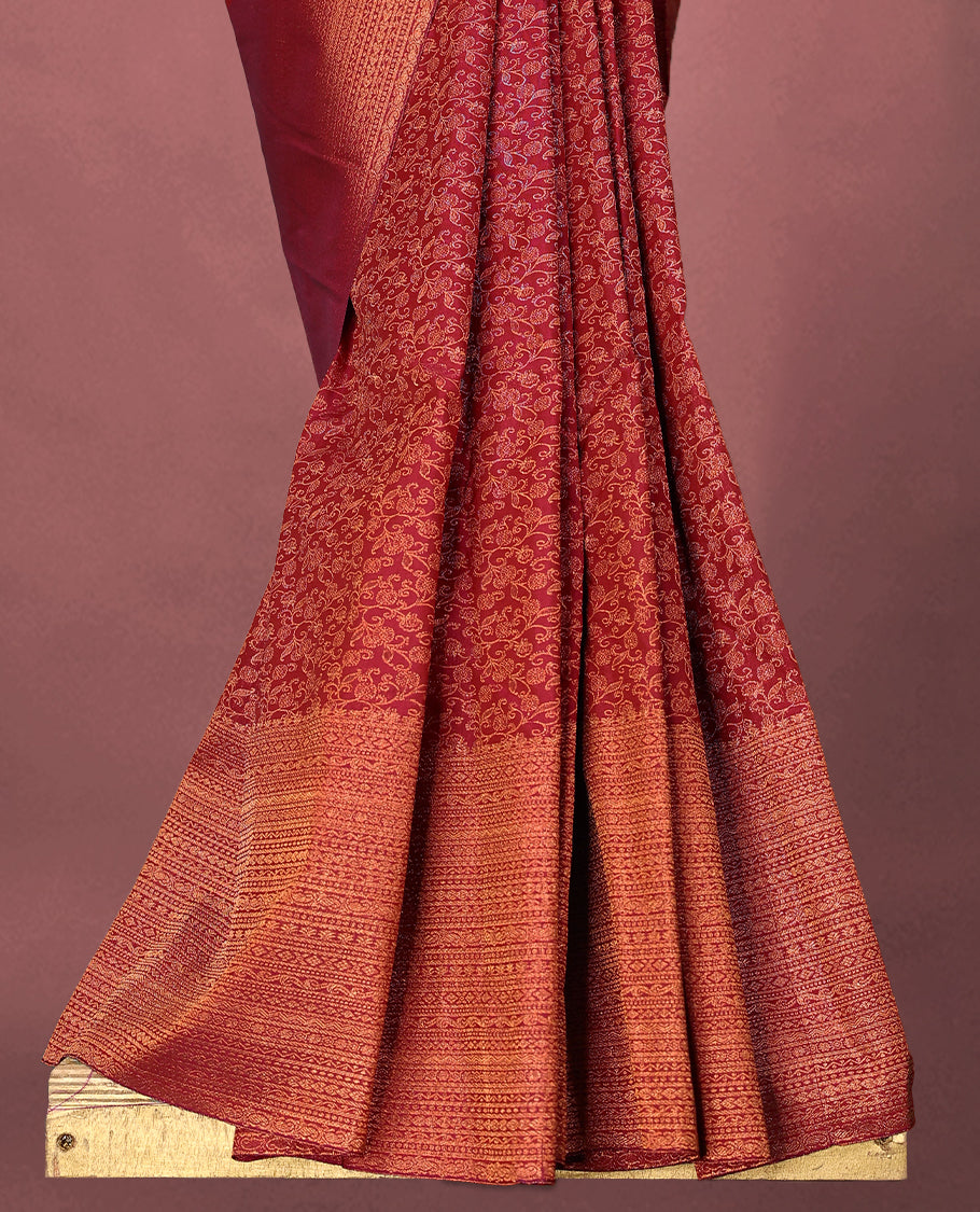 Dark Red colour Kancheepuram saree featuring an antique zari brocade body, complemented by a traditional border and a matching blouse.