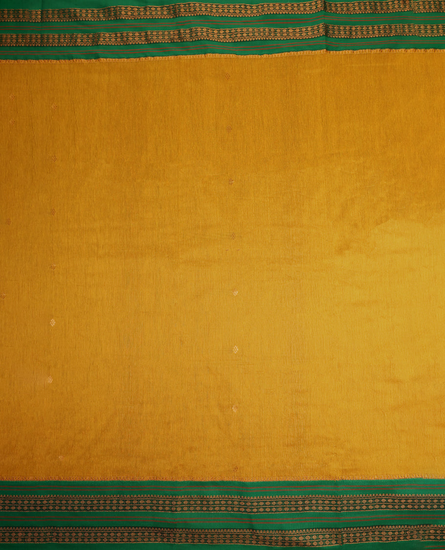 Green and Mustard colour Kalyani cotton saree featuring zari woven patterns across the body, paired with a rich Green colour traditional zari border and pallu, with matching blouse