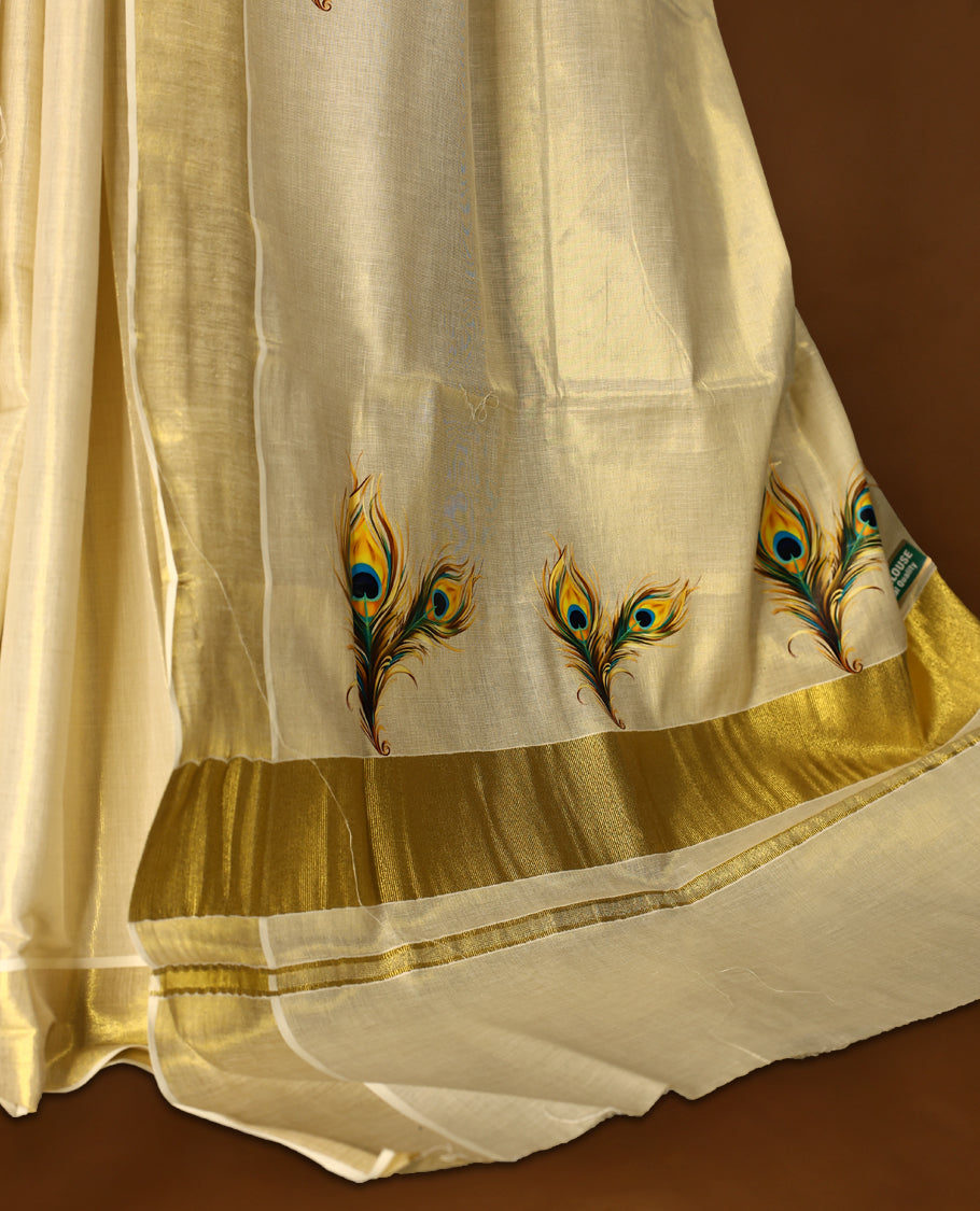 Light Gold colour Tissue Kerala saree featuring Peacock feather prints on body and a beautifully woven Gold Kasavu border, paired with a matching blouse perfect for festive occasions.
