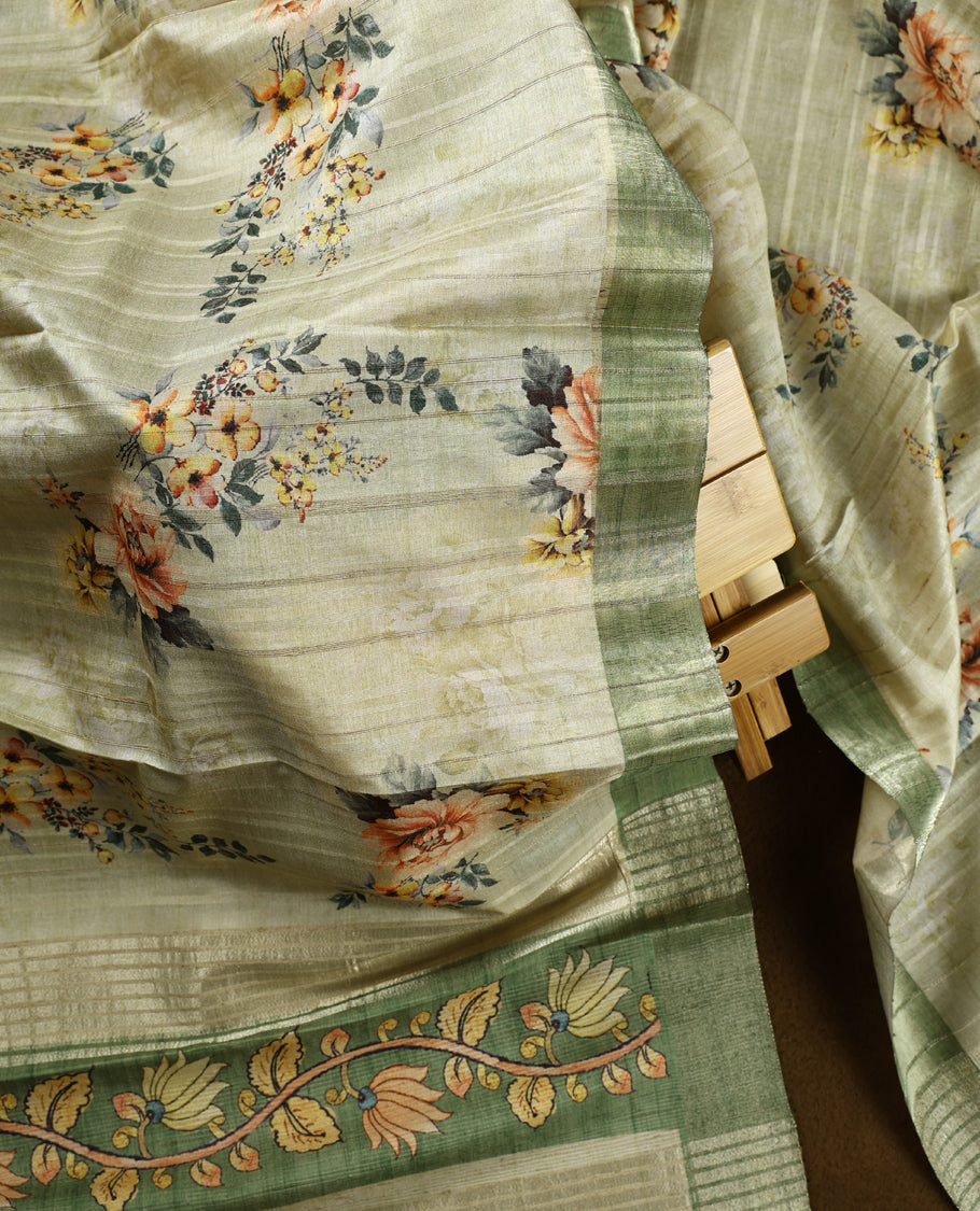 Light green colour churidhar material adorned with floral embroidery and sewn glass beads on the yoke, paired with a plain green bottom and a beige dupatta featuring floral prints.