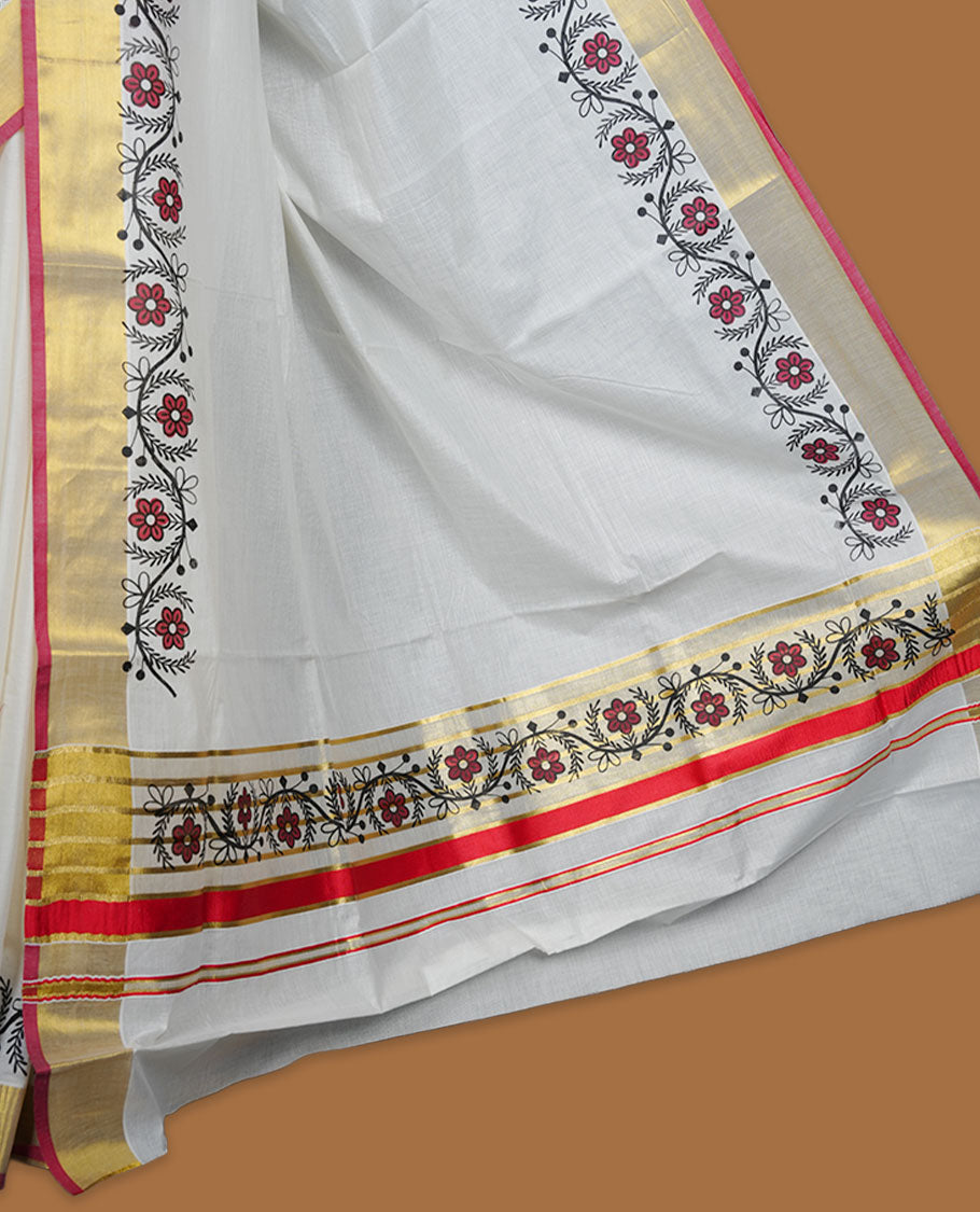 Off white cotton Kerala saree with floral printed borders, highlighted by a golden zari border and classic pallu, paired with a matching blouse.