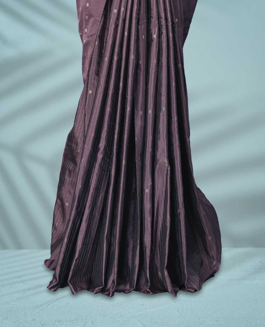 Mauve Colour semi silk saree features subtle square and stripe motifs across the body, comes without a border and paired with a matching blouse.
