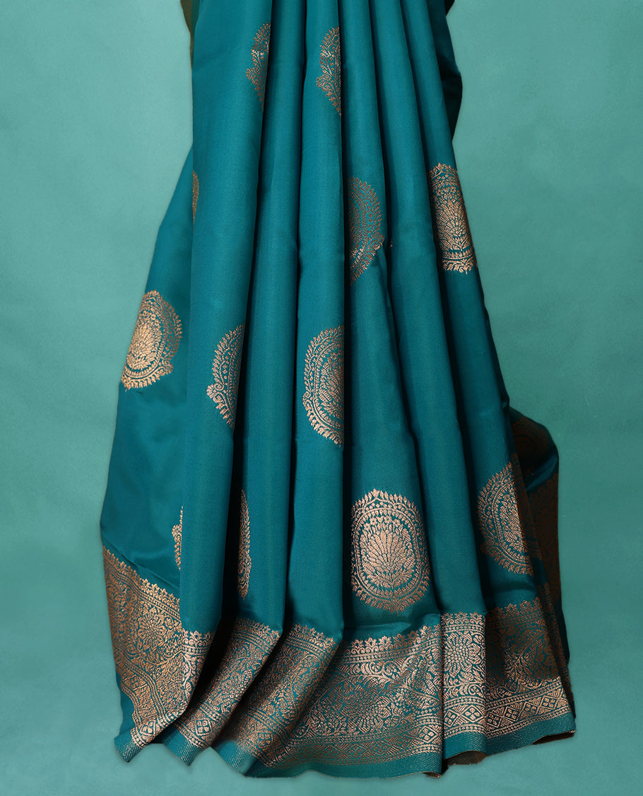 Blue coloured semi silk saree featuring a Golden Zari design on the body, paired with a Self coloured border and matching blouse.
