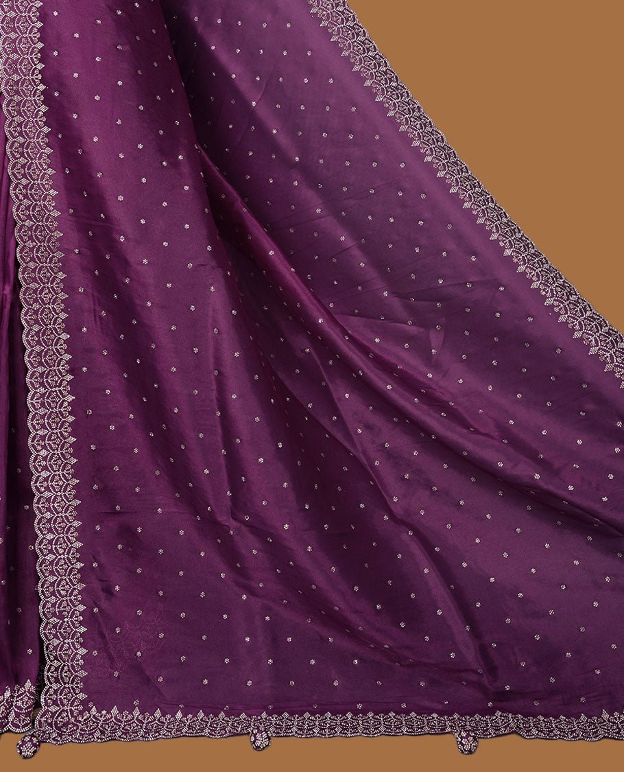 Purple Colour shimmer fancy saree adorned with scattered white stone buttas all over the body, paired with a delicate stone worked border and matching blouse featuring floral vine stone embroidery