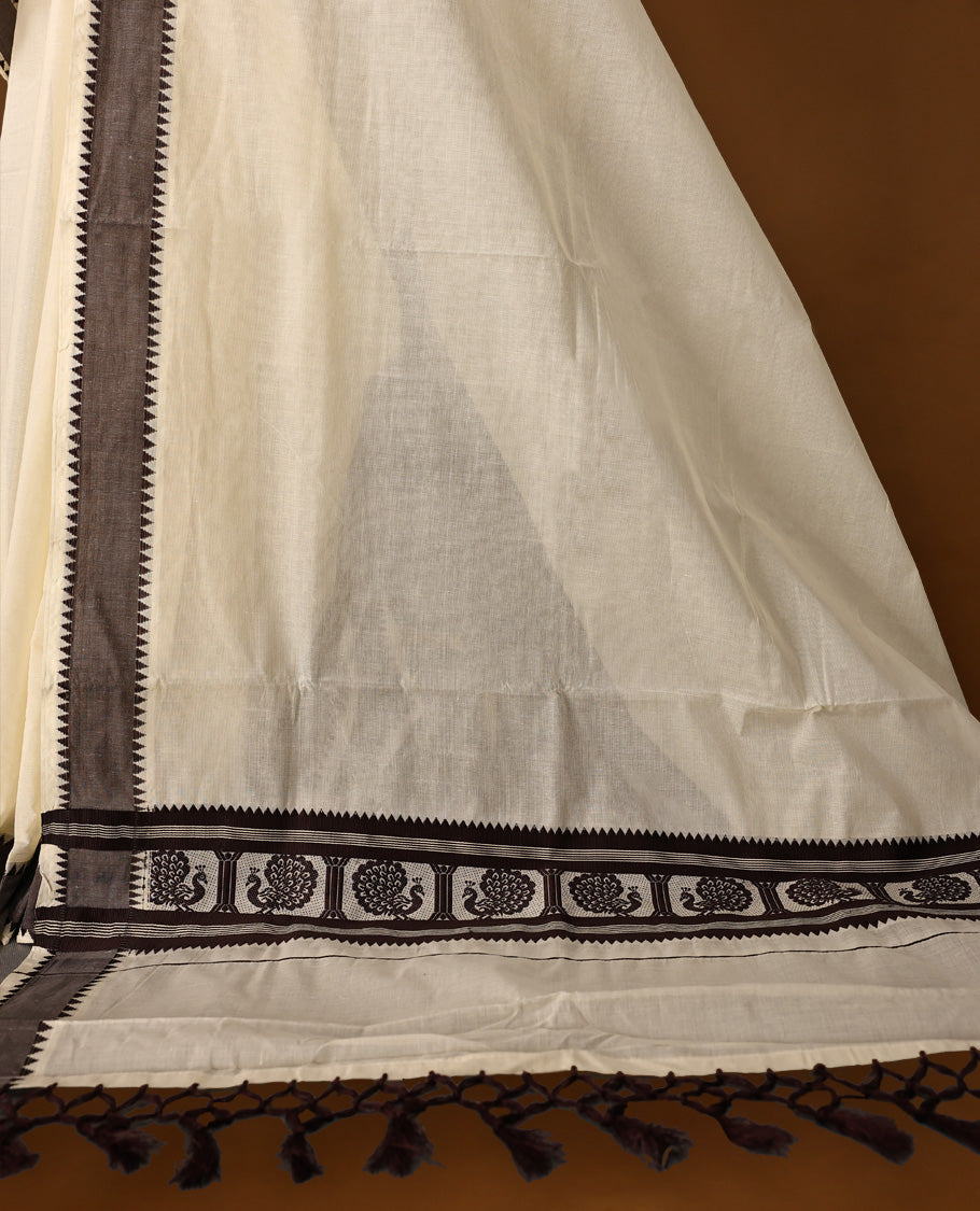 Elegant off white colour cotton Kerala saree featuring Plain body, Dark Chocolate colour border with Peacock Motifs, Paired with matching blouse offering a classic and graceful look, paired with a matching blouse.
