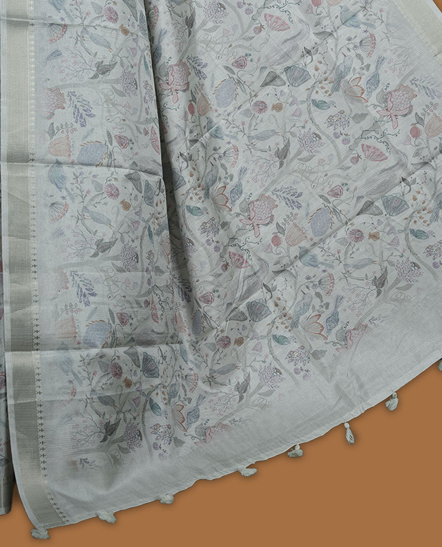 Mint green colour semi tussar silk saree featuring all over floral and leaf motifs on the body with a subtle self border and tasselled pallu, paired with a matching blouse.