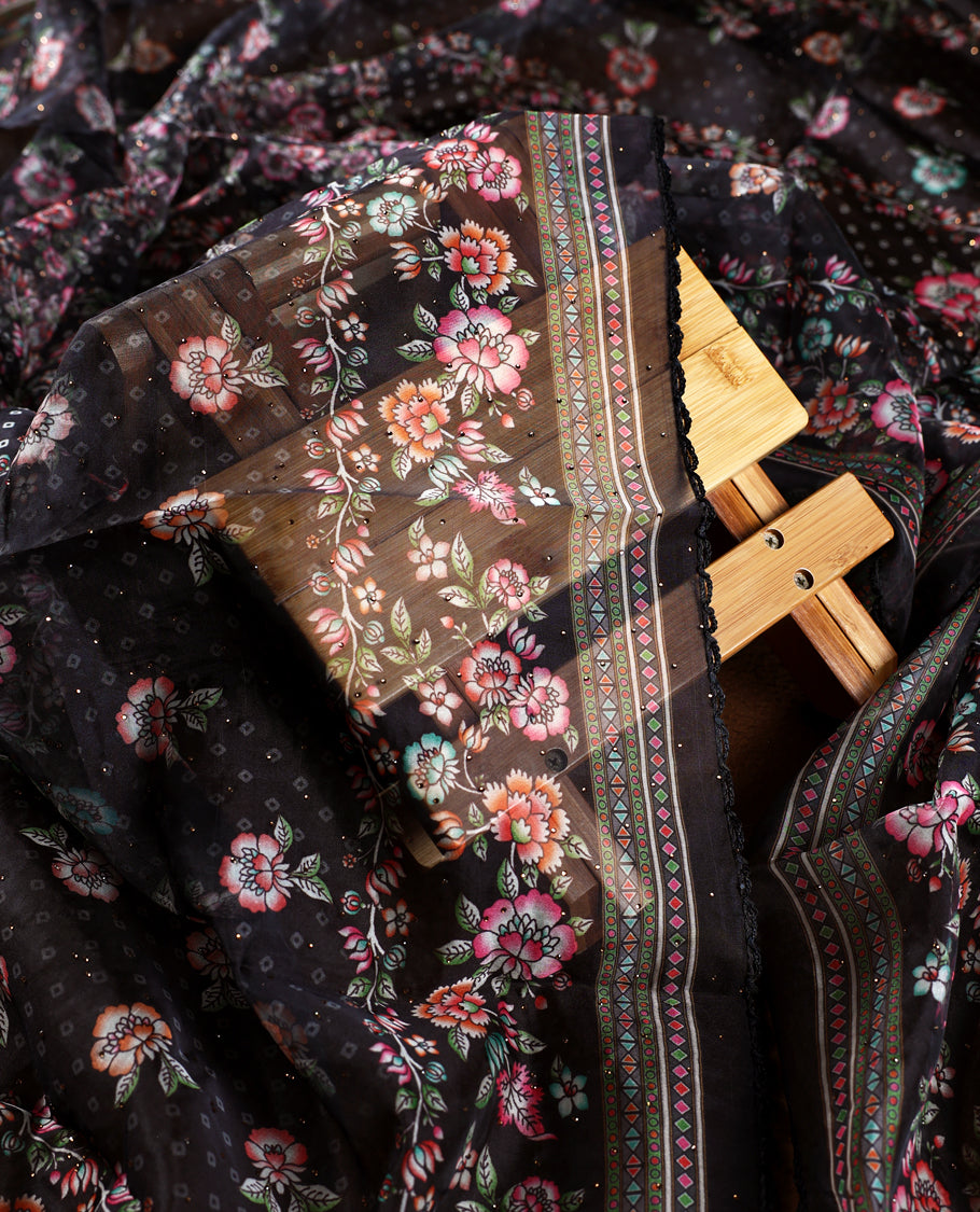 Chic black churidhar material adorned with delicate floral, stone and vine motifs, paired with a vibrant printed dupatta and plain matching bottom, offering a perfect blend of elegance and festive charm.
