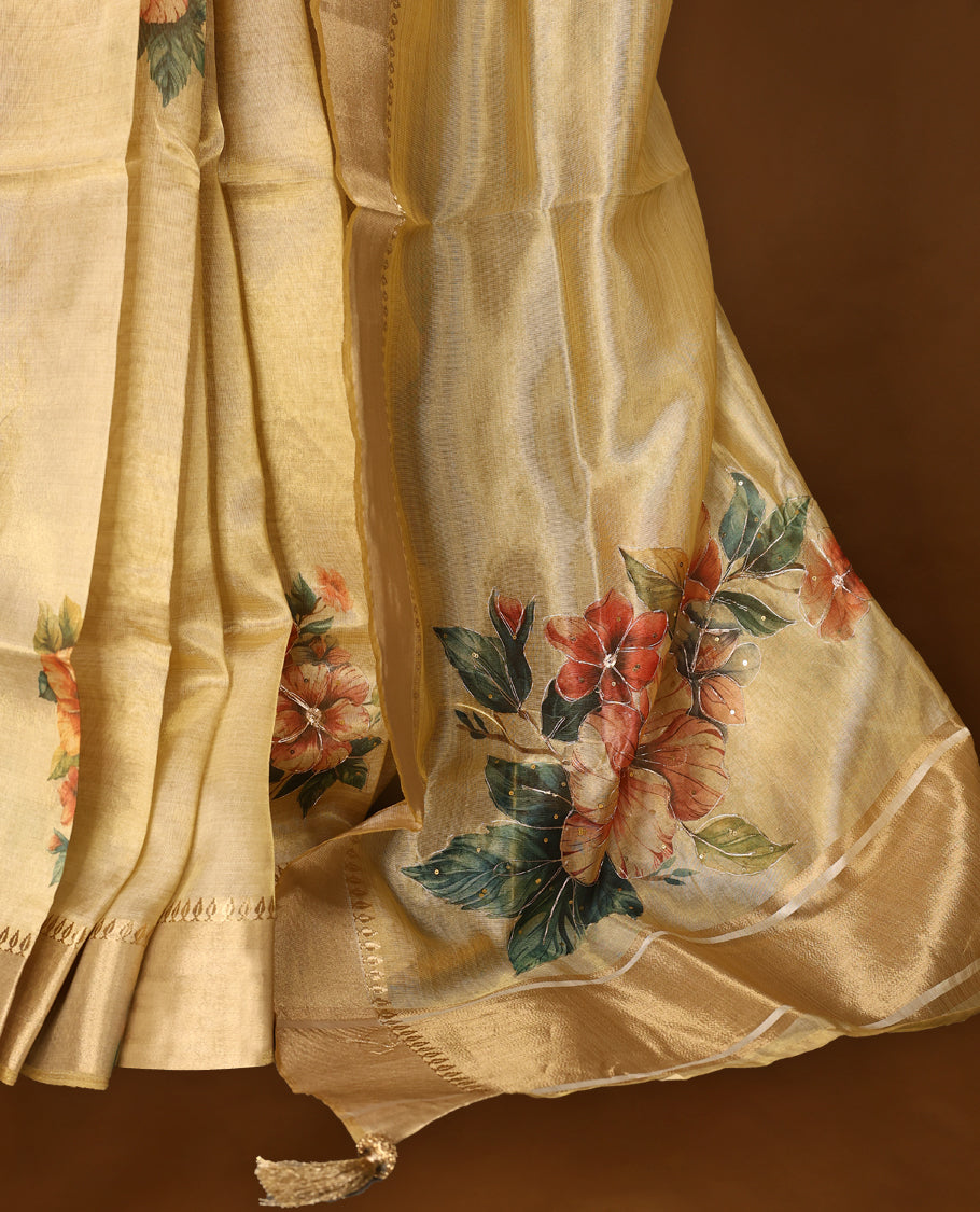 Light gold colour Organza Kerala saree featuring a smooth body with a subtle sheen, highlighted by a sleek golden zari border and delicate floral prints detailed with thread and sequence work near the pleats, Paired with a matching blouse.