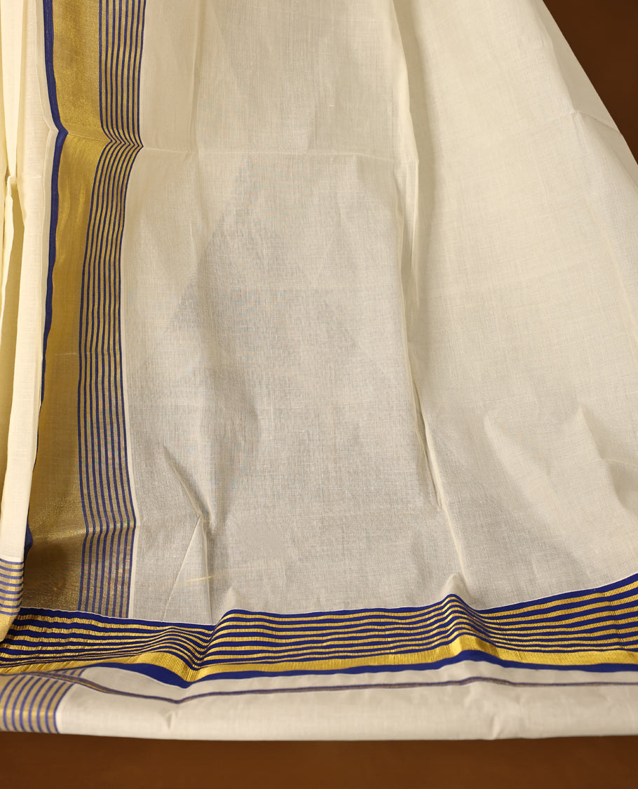 Elegant pure cotton Kerala saree with a cream base, golden zari border, and fine blue stripes & A perfect blend of tradition and simplicity, ideal for festive and cultural occasions and Paired with a matching blouse piece.