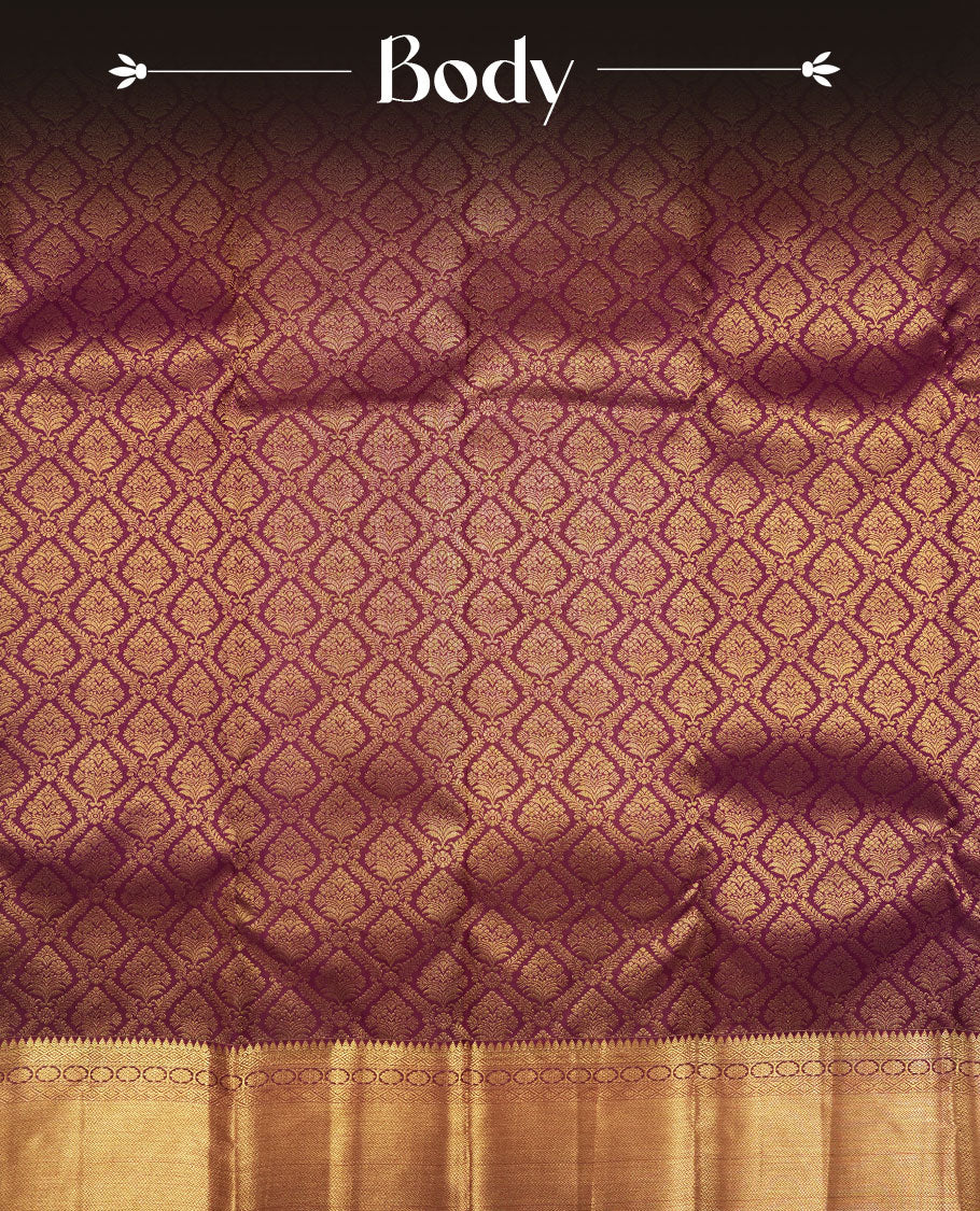 Dark burgundy colour Kanchipuram pattern Manthrakodi saree featuring metallic golden floral and leaf motif zari jaquard with kanchipuram traditional bavanji border and plain blouse piece with zari border.