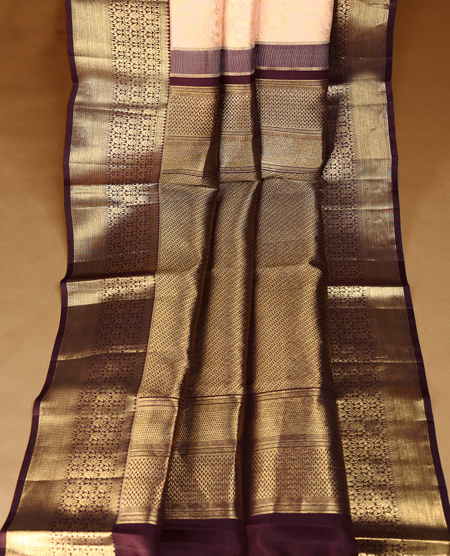 Soft blush Colour traditional Kancheepuram silk saree adorned with antique zari floral kodi motifs on the body, featuring a dark maroon border with rich, heavy golden zari floral Kodi patterns, and paired with a matching blouse.