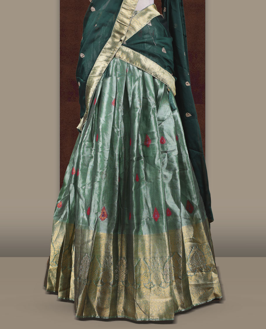 Light green colour Dhavani set featuring a Green colour skirt with contrast Gold colour border with rich gold zari pattern, paired with a Matching dupatta detailed with Gold motifs