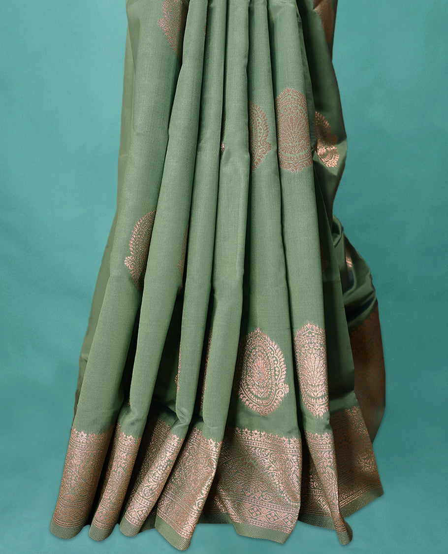Pale Green coloured semi silk saree featuring a Golden Zari Butta design on the body, paired with a Self coloured border and matching blouse.