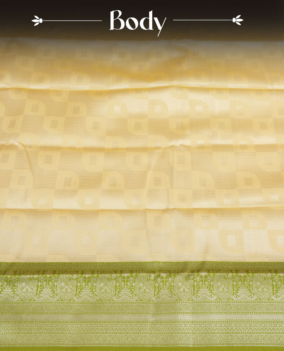 Light cream colour semi silk saree adorned with silver zari designs on the body, complemented by a contrasting olive green border and pallu, and paired with a matching blouse piece.
