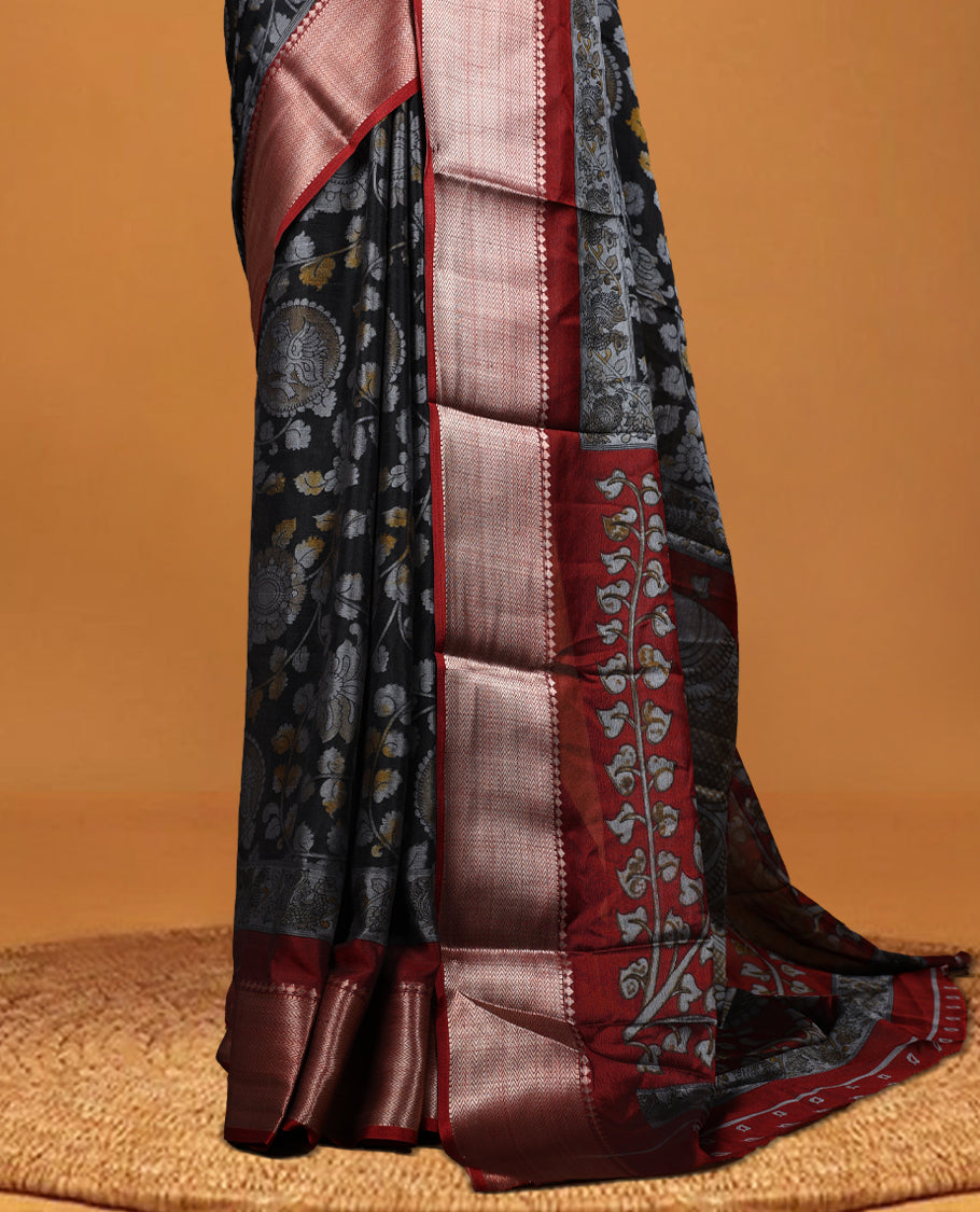 Black colour saree adorned with intricate floral motifs in subtle hues, featuring a rich maroon zari border and a beautifully woven contrasting pallu & Comes with a matching blouse piece.
