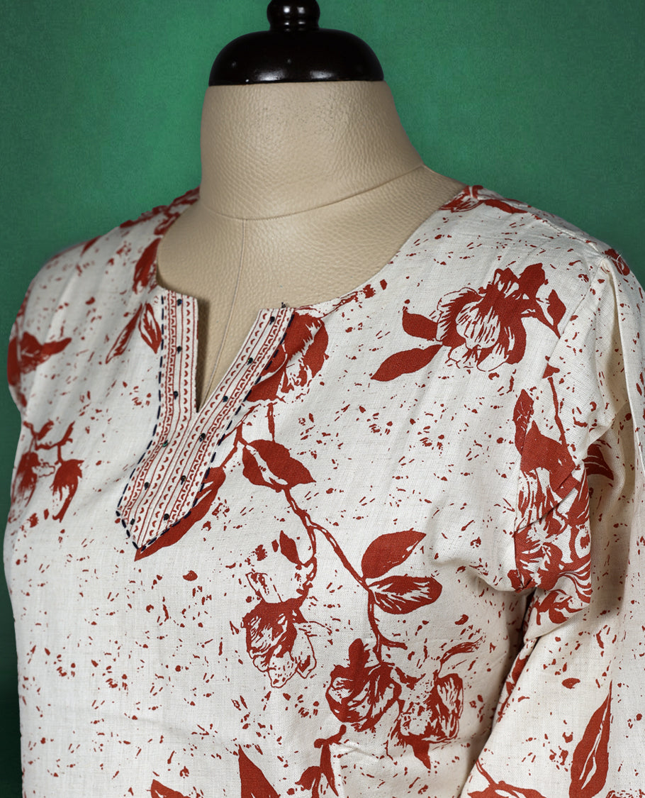 Beige colour short kurti with brown floral prints and intricate border detailing on the hem and sleeves, featuring a V slit round neckline and 3/4th sleeves, perfect for everyday comfort and style.