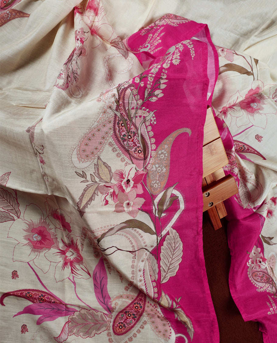 Cream colour churidhar material with pink floral and paisley prints, enhanced by a magenta border and delicate embroidery & Comes with matching plain bottom and dupatta.