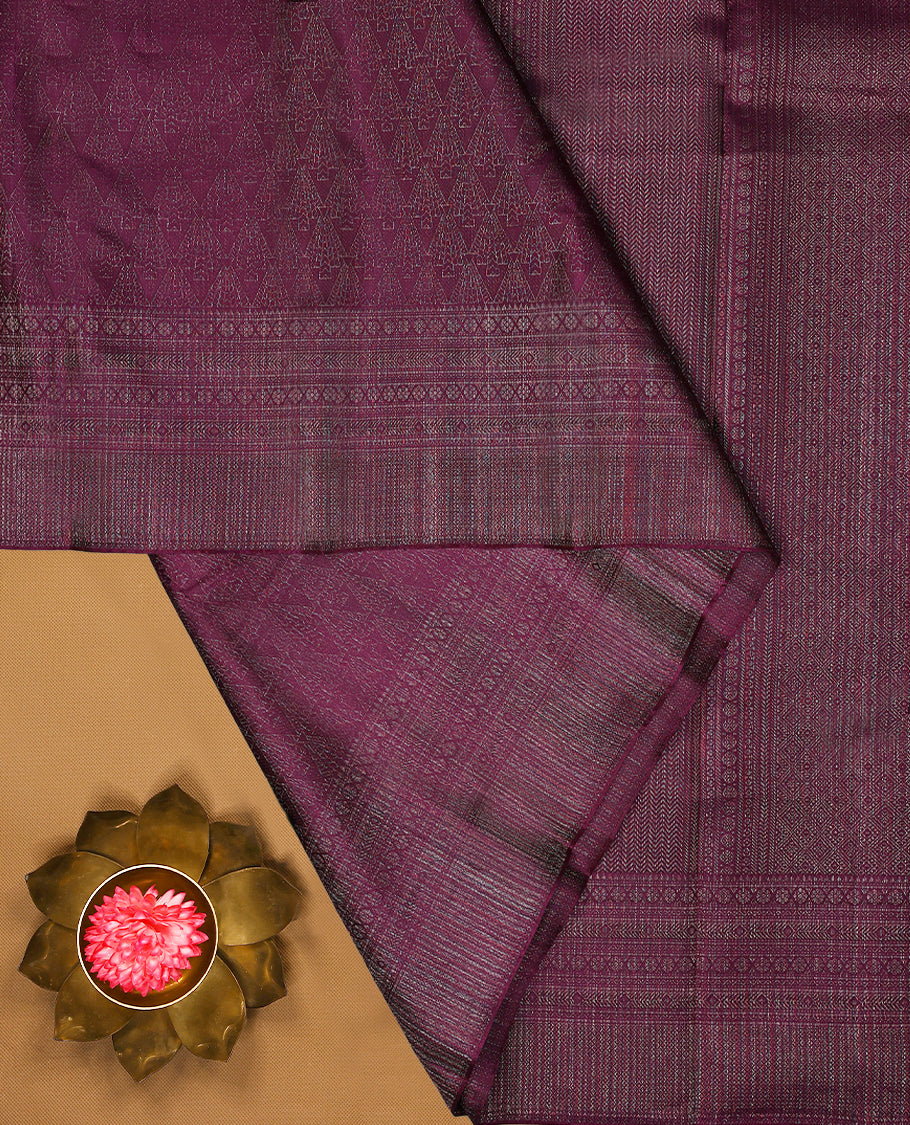 Grape coloured Manthrakodi saree featuring a multicoloured zari jacquard body, complemented by a self coloured turning Banarasi border and a matching self coloured blouse.