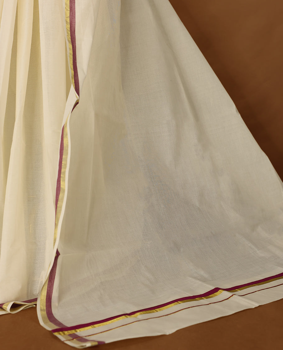 Elegant off white colour cotton Kerala saree featuring a plain body and traditional golden zari border with a hint of Grape purple, offering a classic and graceful look, paired with a matching blouse.