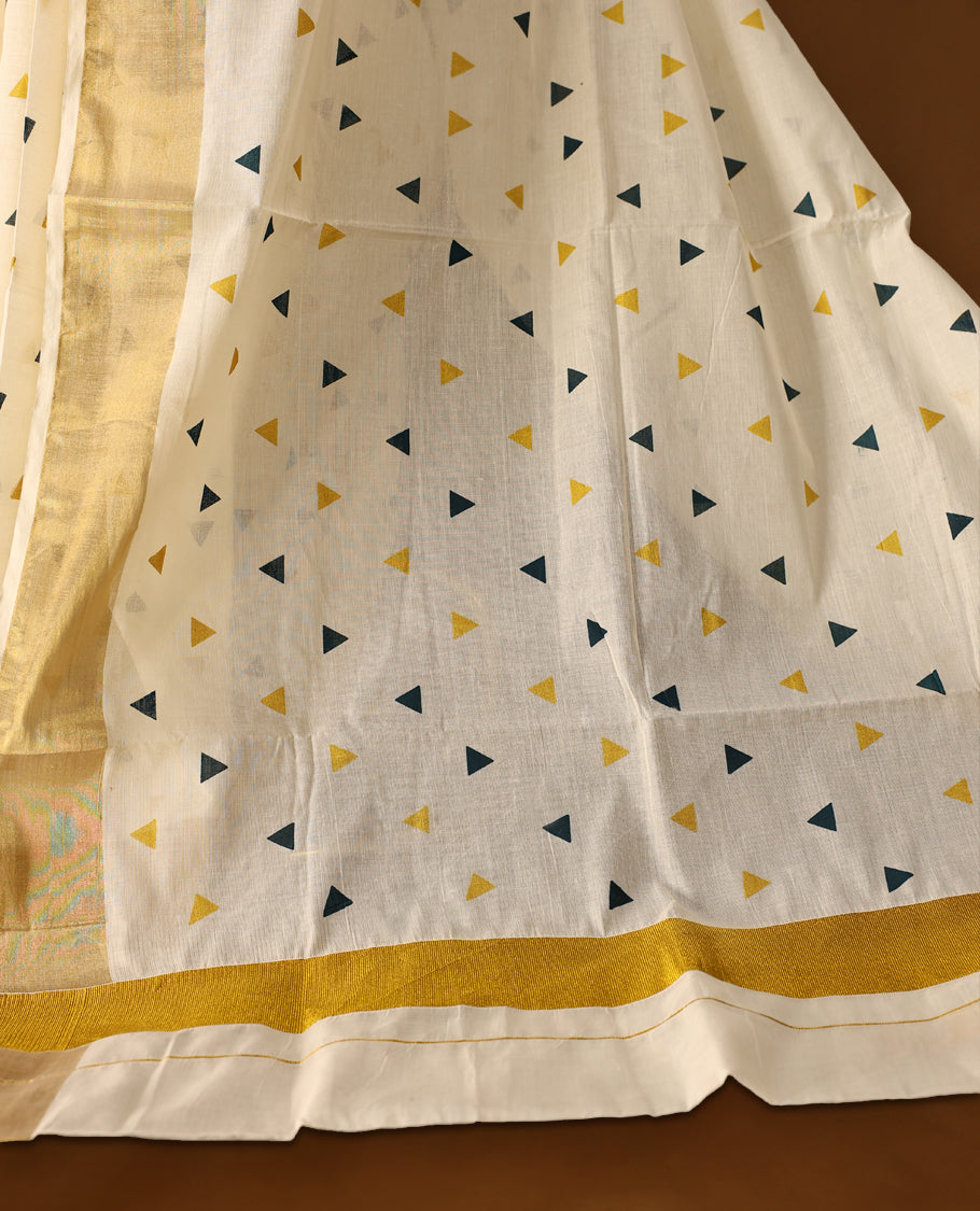 Elegant off white colour cotton Kerala saree featuring Midnight Blue and Gold Triangle prints on the body and traditional golden zari kasavu border offering a classic and graceful look, paired with a matching blouse.
