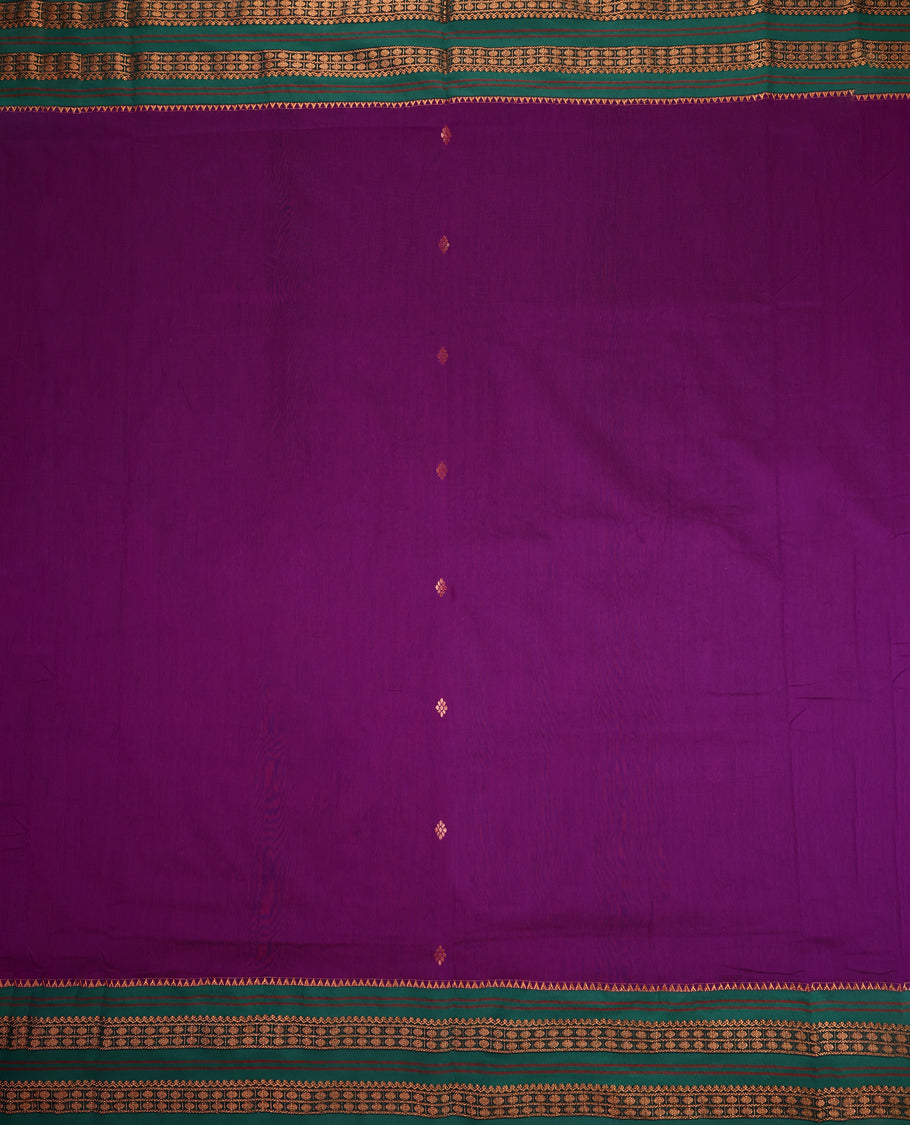 Grape and Green Kalyani cotton saree adorned with delicate buttas across the body, complemented by intricately woven golden zari patterns on the border and pallu, paired with a matching blouse