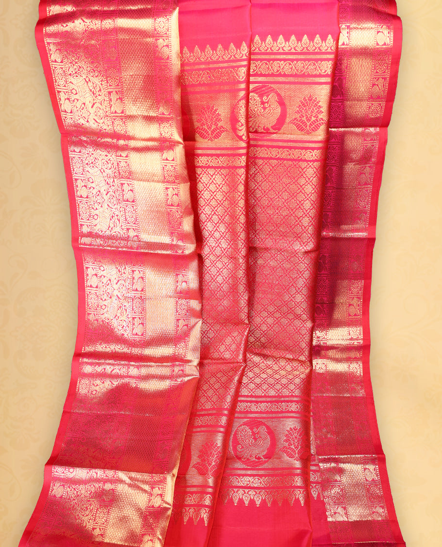 Rani pink colour pure Kancheepuram saree with gold zari Banarasi paisley mango motifs on the body traditional border with elephant peacock and chackram pattern grand pallu with floral chackara motifs paired with matching blouse