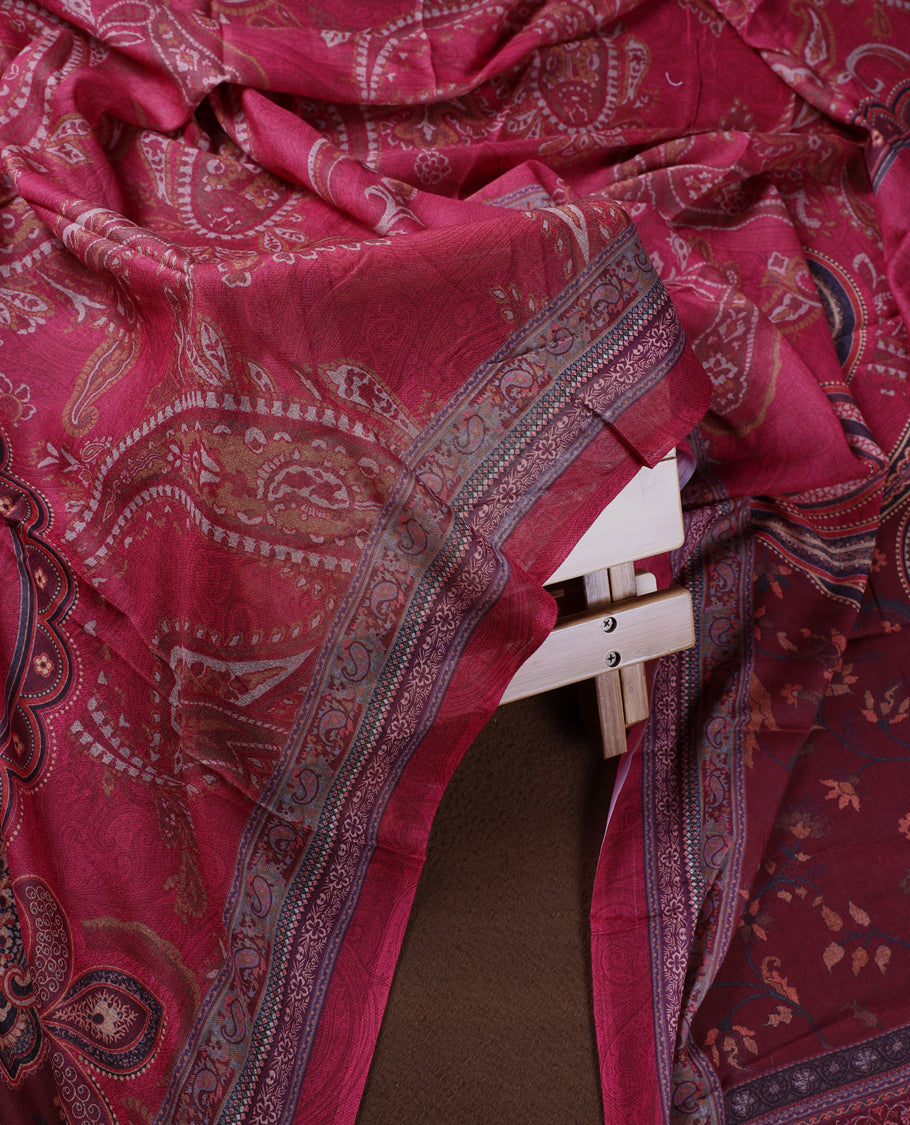 Medium maroon colour churidhar material featuring intricate paisley prints and delicate embroidery with stone highlights, paired with a plain matching bottom and a printed dupatta.