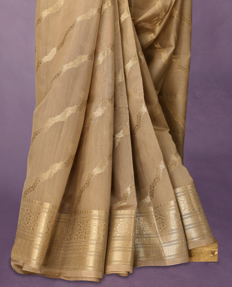 Beige colour pure Banarasi Chanderi cotton, beautifully adorned with traditional antique zari Cross Kodi designs across the body, completed with a hand-dyed colour, a traditional border, and a matching blouse.