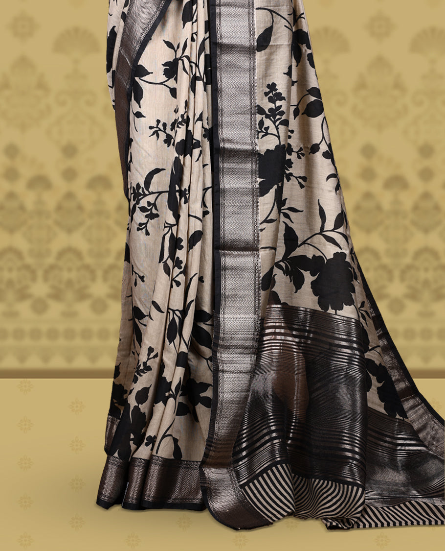 Beige colour saree adorned with bold black floral prints and a rich black zari border and stripped checkered pallu & Comes with a matching blouse piece.
