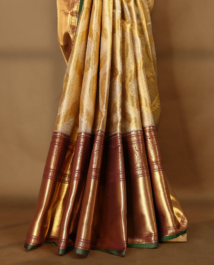 Gold colour tissue brocade saree with gold and silver zari Bold pattern on body, gold zari traditional mango and peacock work brown & green border, rich matching pallu with Antique zari motifs, paired with matching blouse.