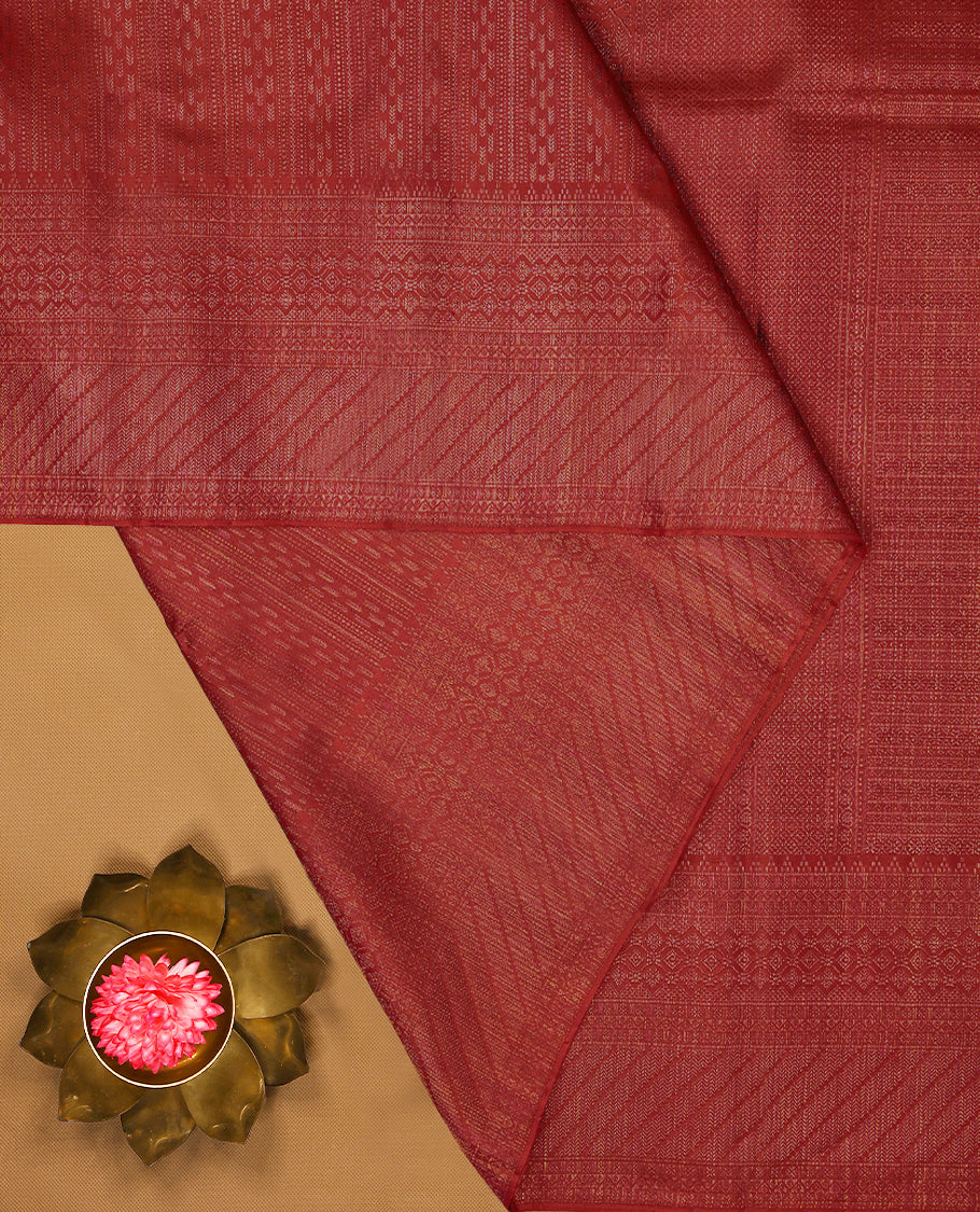 Red coloured Manthrakodi saree featuring a multicoloured zari jacquard body, complemented by a self coloured turning Banarasi border and a matching self coloured blouse.