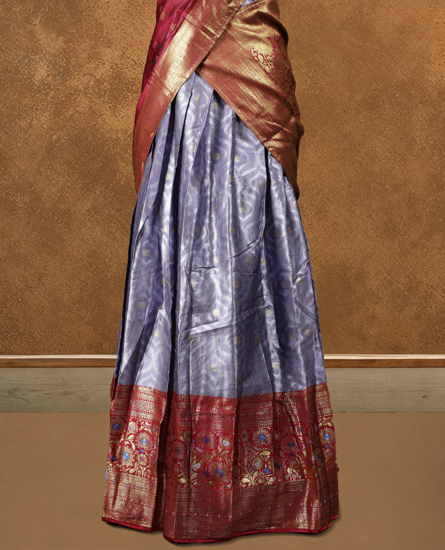 Charming Semi stitiched lavender and red Dhavani set featuring a lustrous lavender skirt with rich golden zari border, paired with a contrasting red dupatta detailed with golden motifs, perfect for festive and wedding occasions.