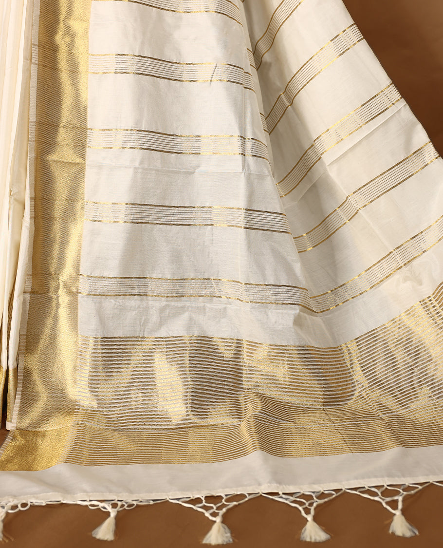 Elegant white colour sotf  Tussar Kerala saree featuring Bold Gold Zari stripes on body, Gold kasavu border, Rich Pallu, Paired with matching blouse offering a classic and graceful look