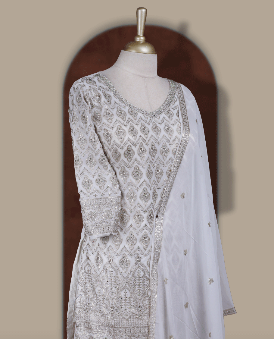 Elegant Off white colour embroidered sharara set featuring intricate copper toned thread work and delicate stones & sequin detailing, paired with a graceful off white dupatta adorned with subtle motifs and a beautifully flared embroidered bottom.