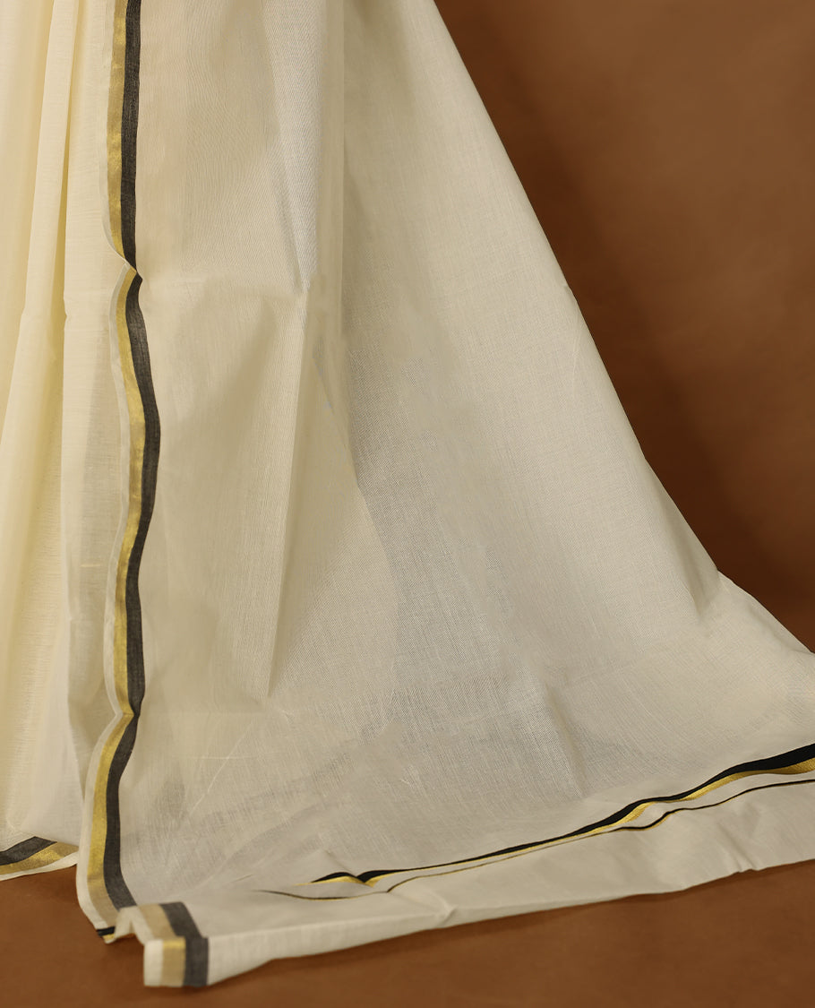 Elegant off white colour cotton Kerala saree featuring a plain body and traditional golden zari border with a hint of Pure Black, offering a classic and graceful look, paired with a matching blouse.